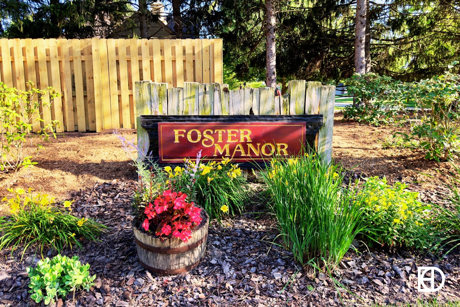 Exterior photo of Foster Manor, showing signage and landscaping