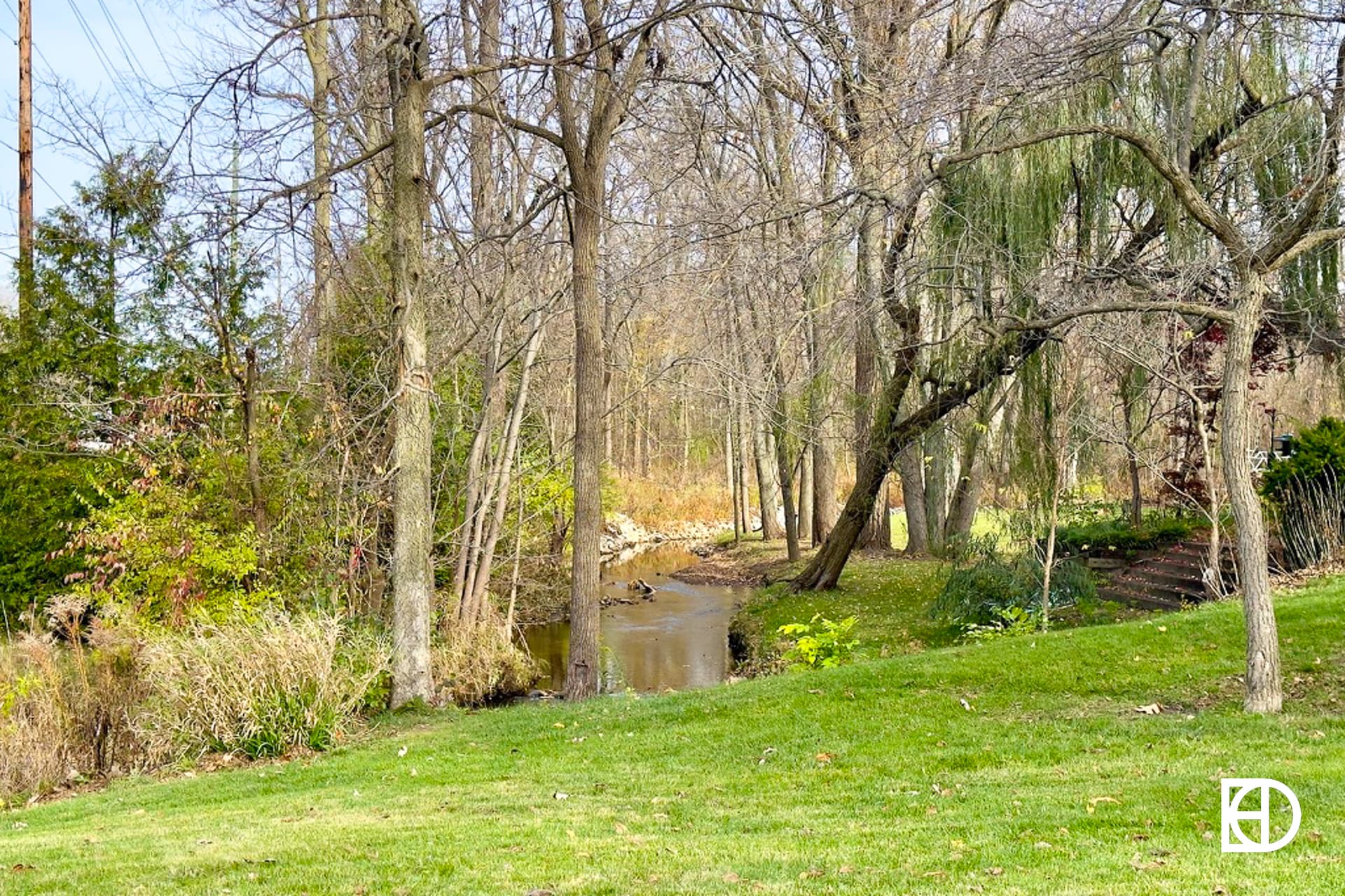 Exterior photo of Williams Creek Farms, showing green space, trees, and creek
