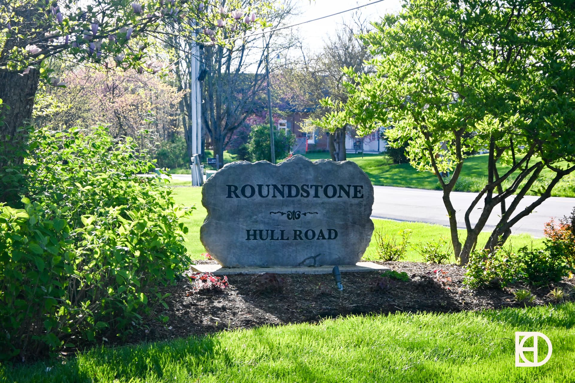 Exterior photo of Roundstone, showing signage and landscaping