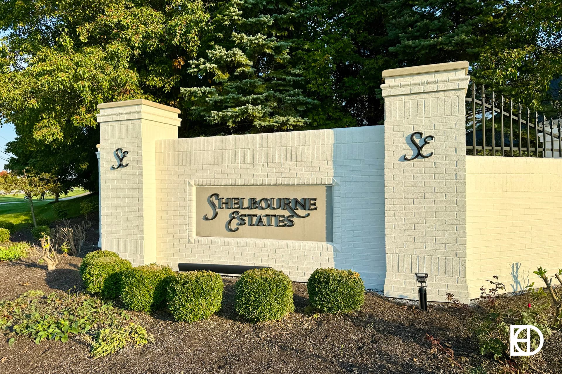 Exterior photo of Shelbourne Estates, showing signage and landscaping