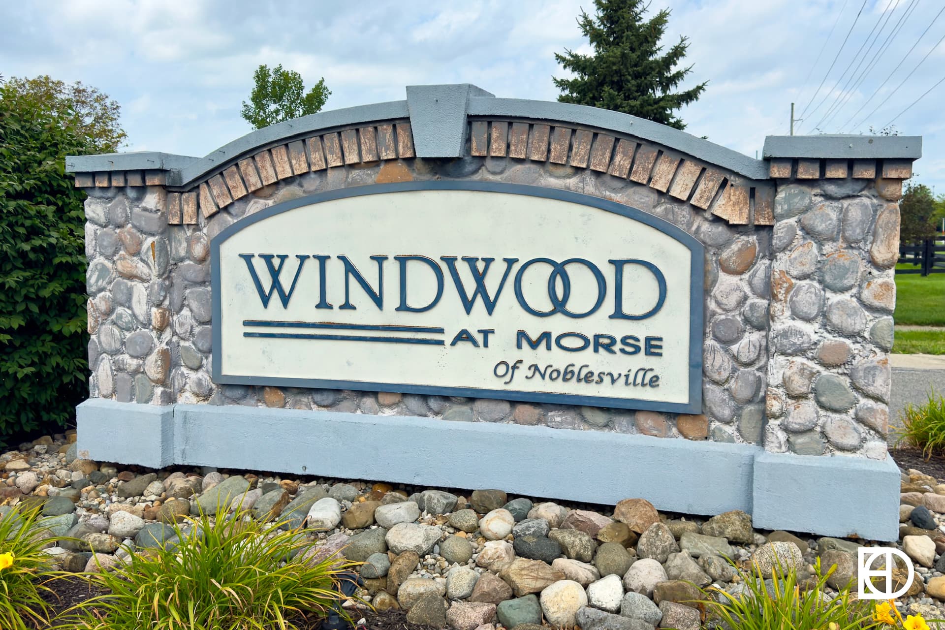 Exterior photo of Windwood at Morse, showing signage and landscaping