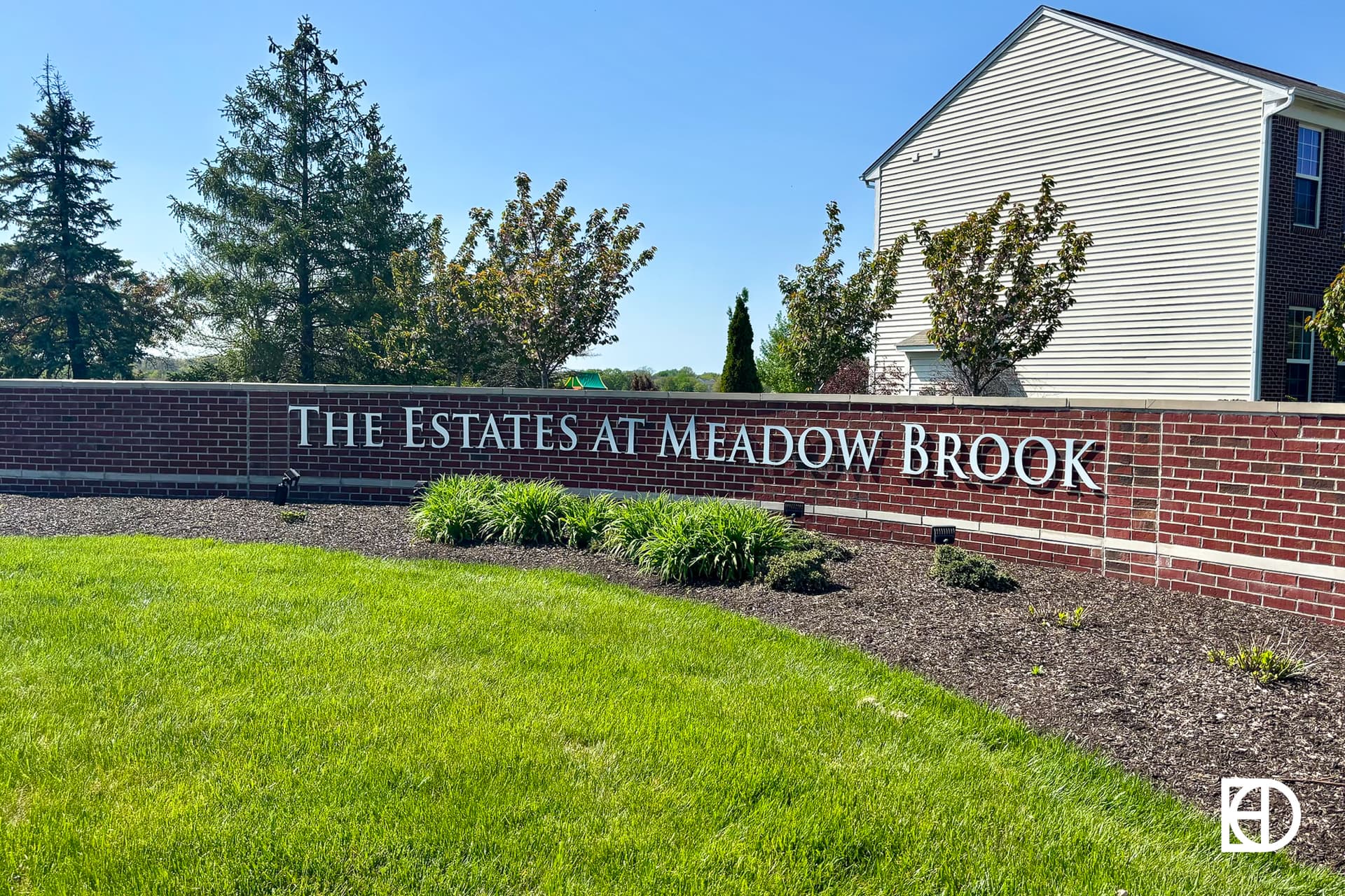 Signage, landscaping, and trees in The Estates at Meadow Brook (Fishers)