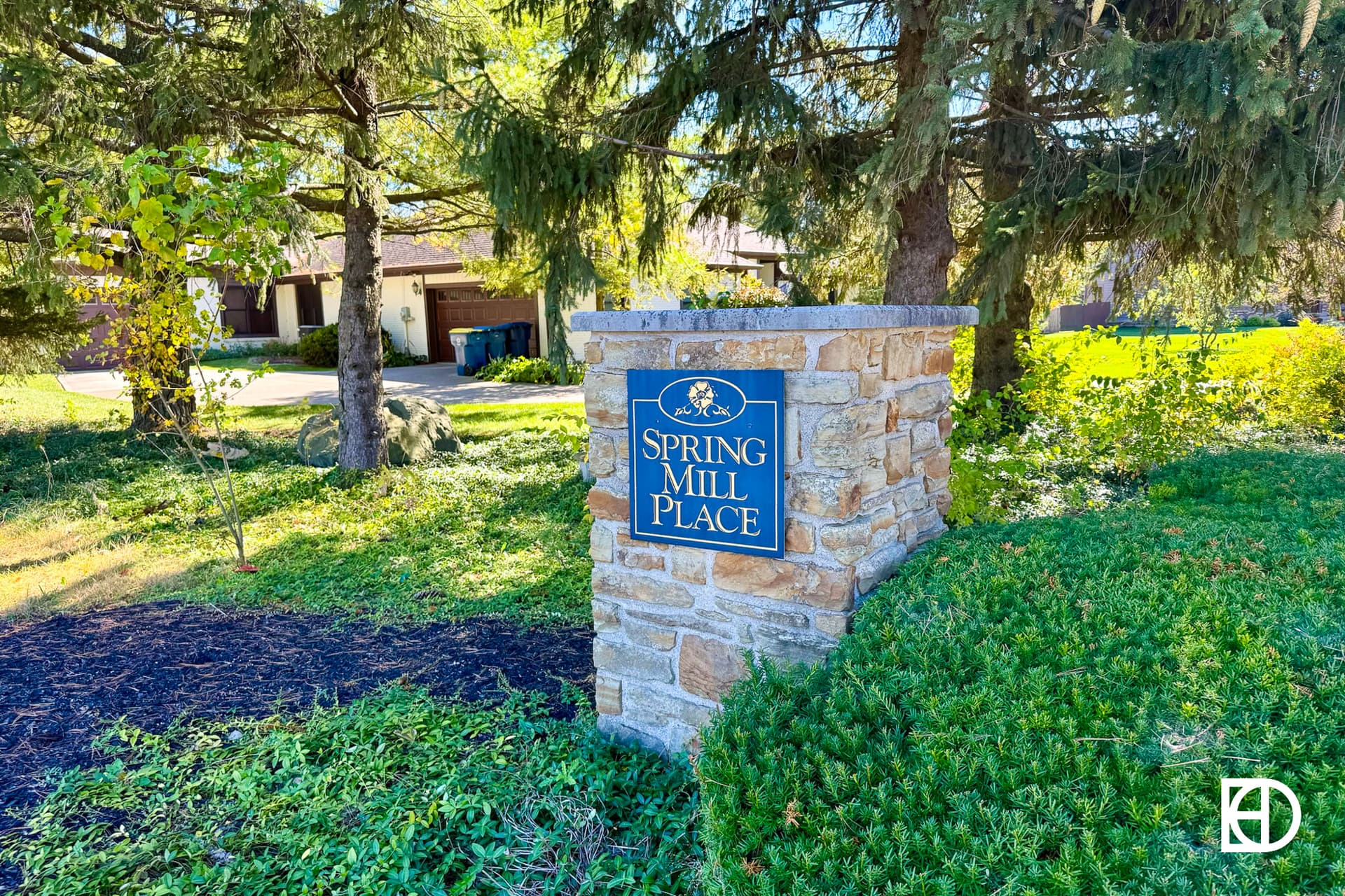 Exterior photo of Spring Mill Place, showing signage and landscaping