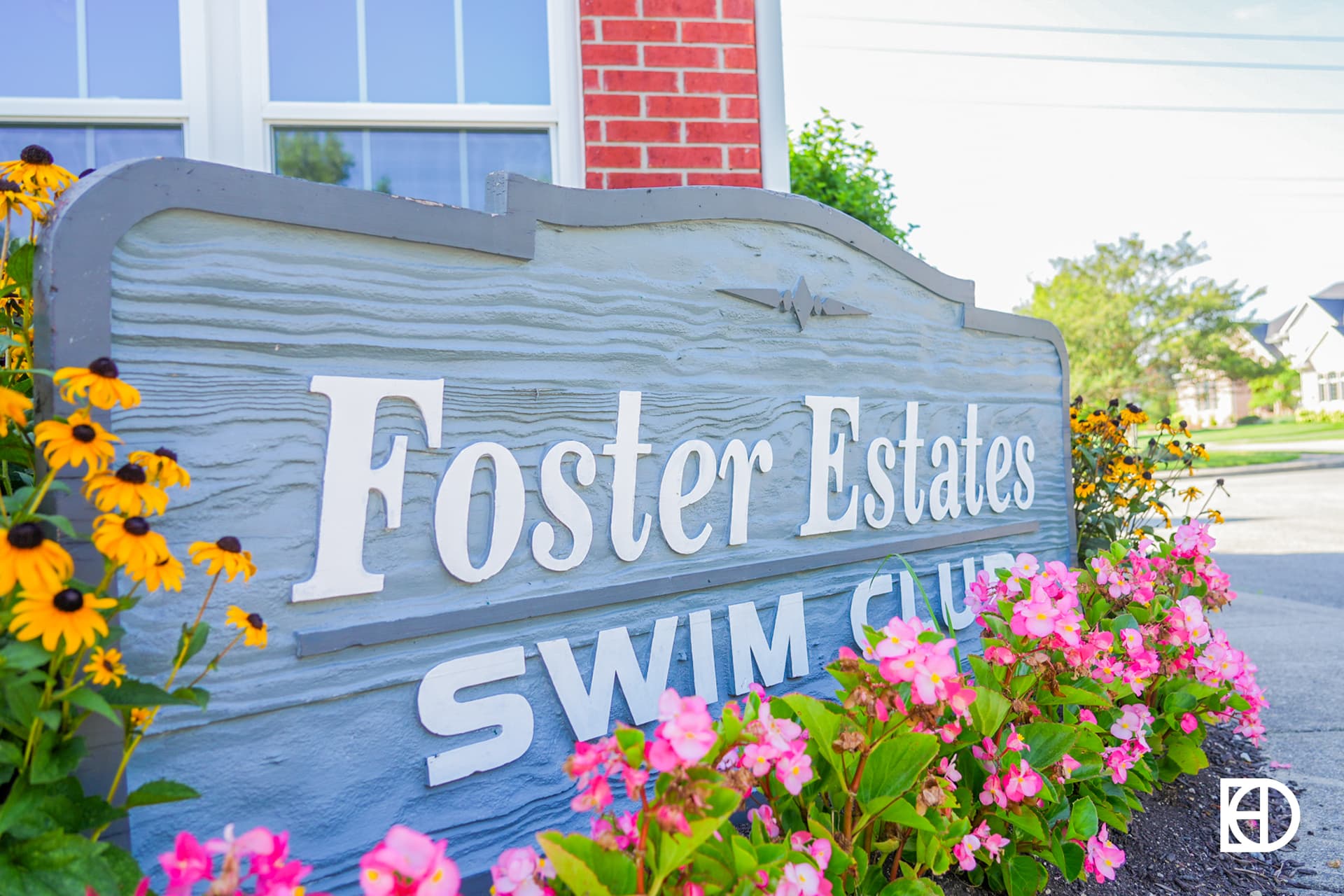Exterior photo of Foster Estates, showing signage and landscaping