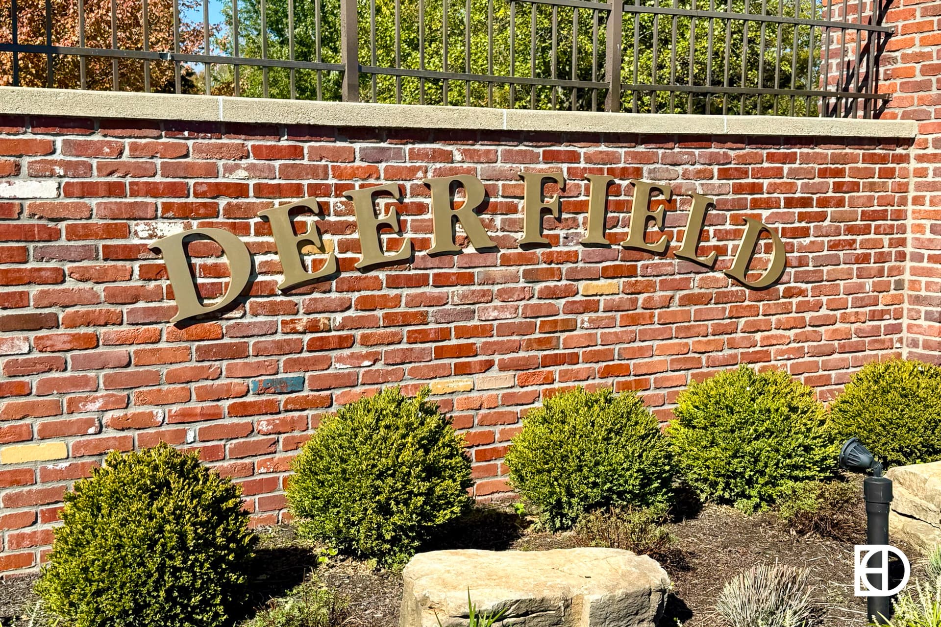 Exterior photo of Deefield, showing signage and landscaping