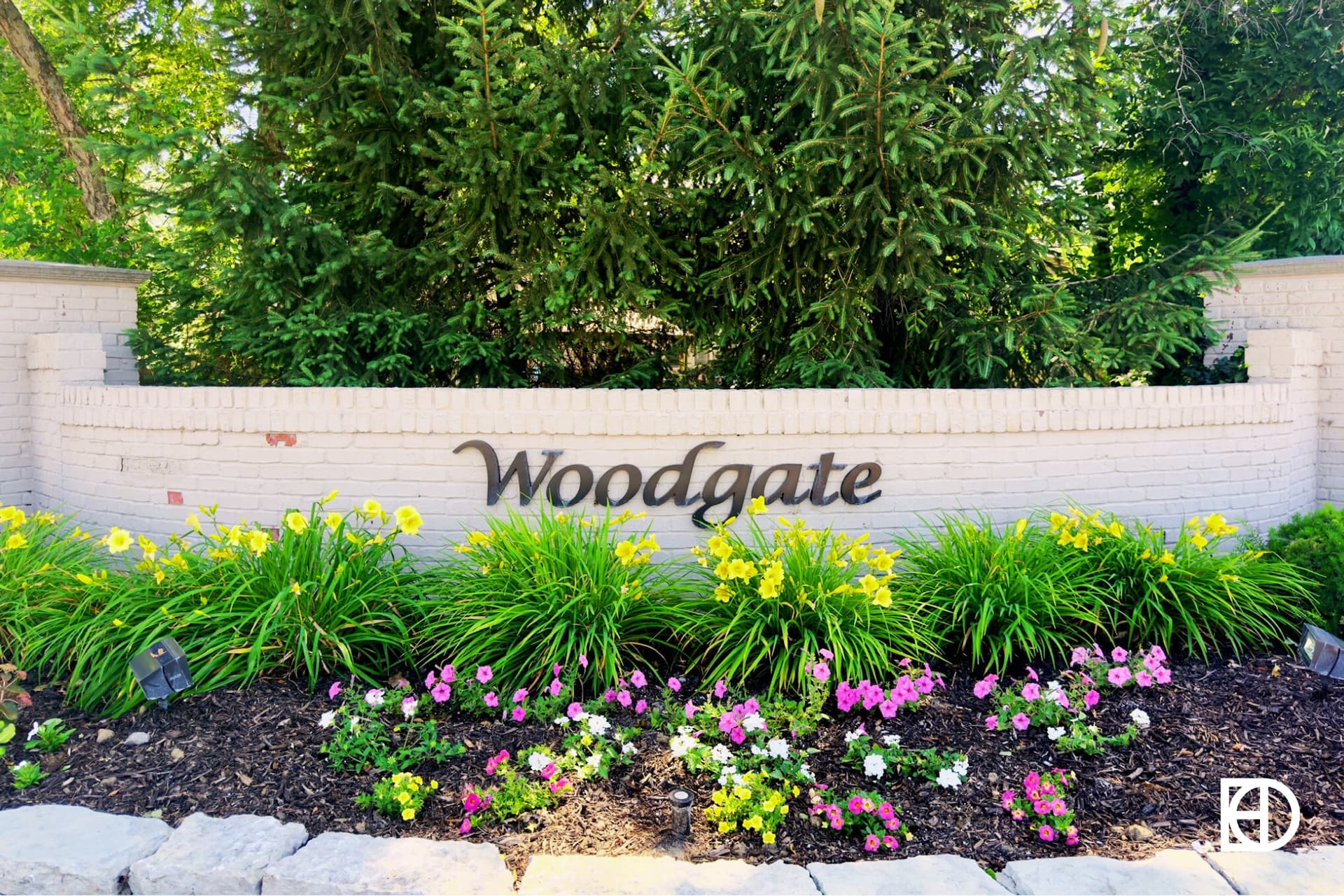 Exterior photo of Woodgate, showing entrance signage and landscaping