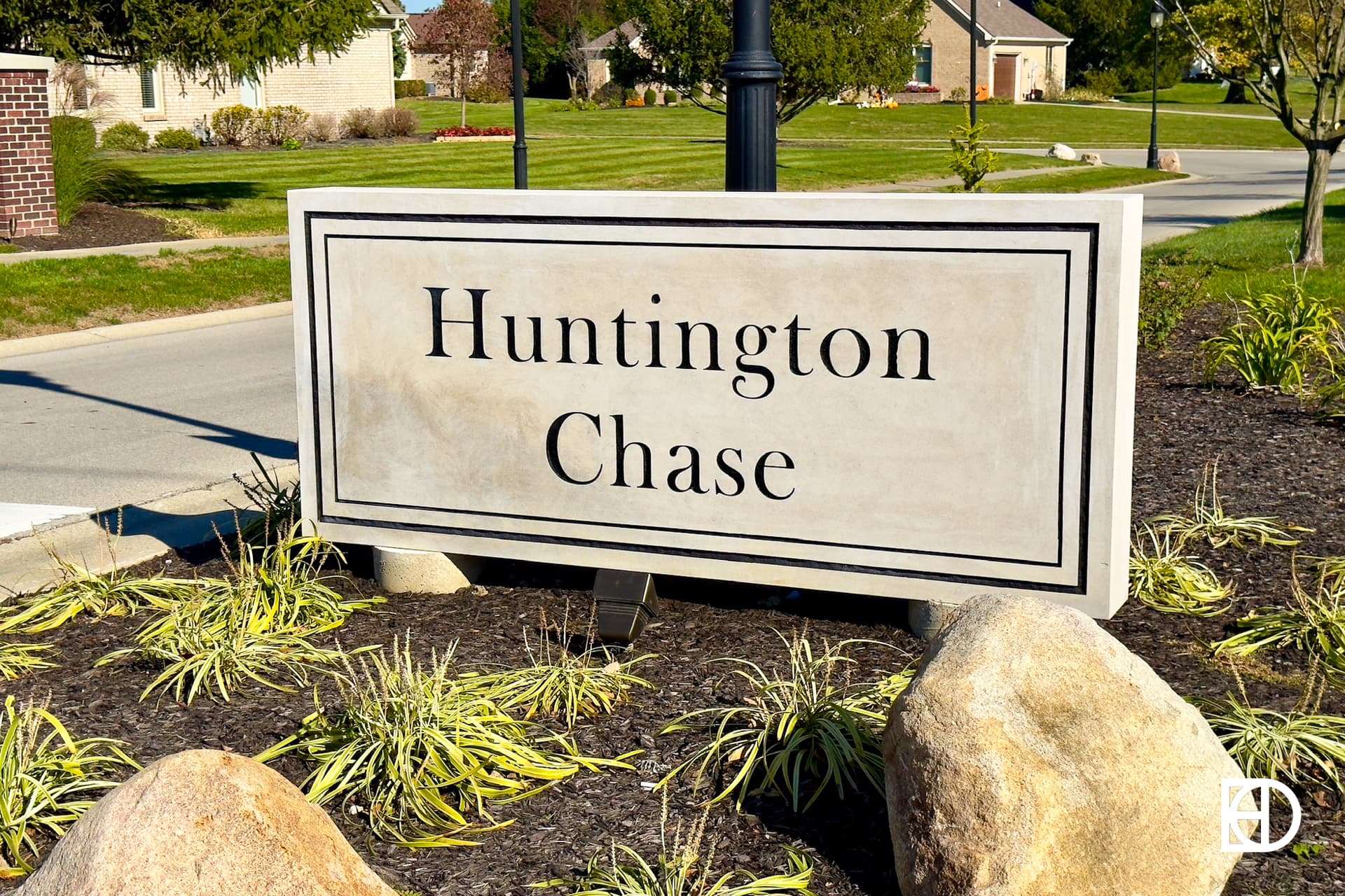 Exterior photo of Huntington Chase, showing signage and landscaping