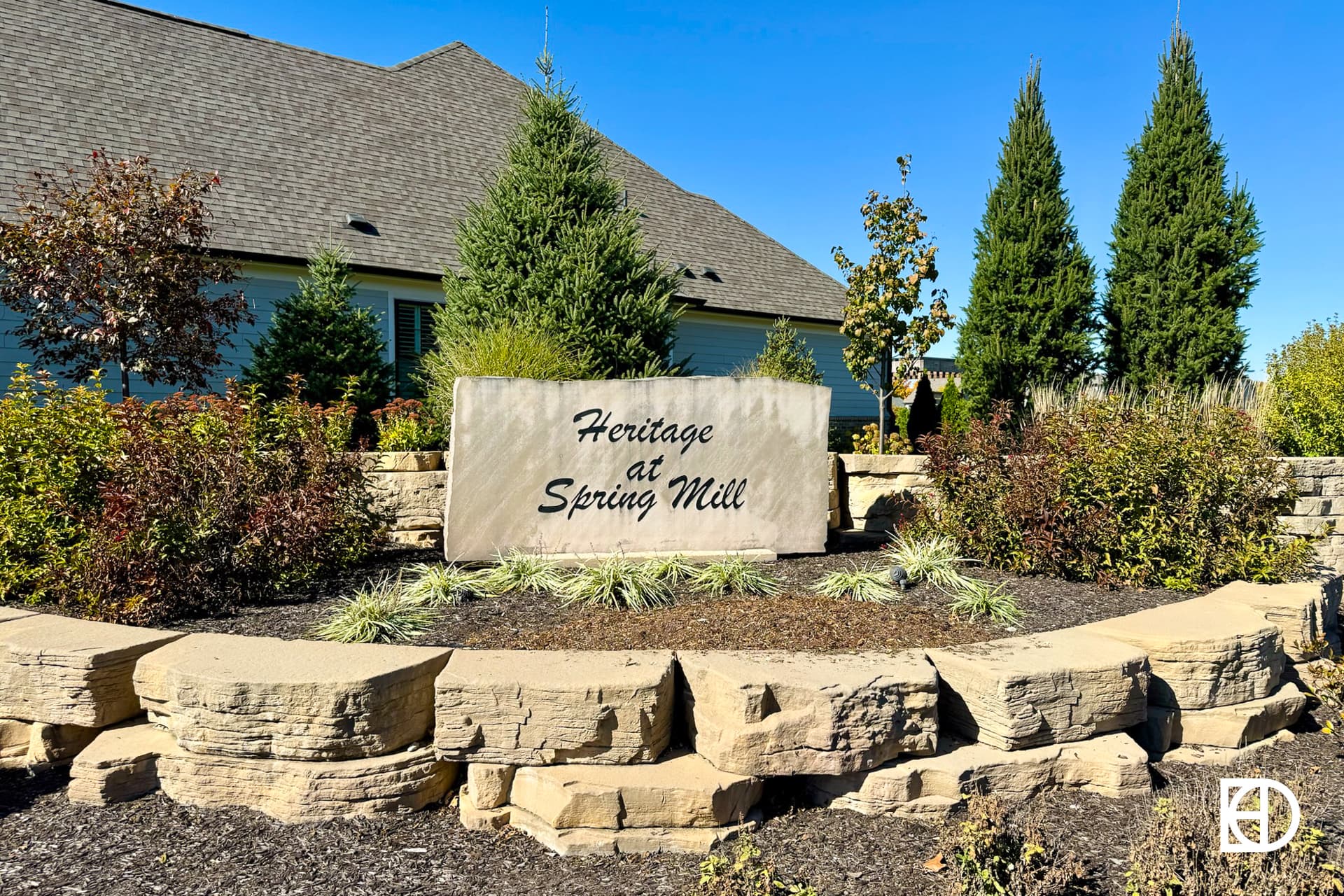 Exterior photo of Heritage at Spring Mill, showing signage and landscaping