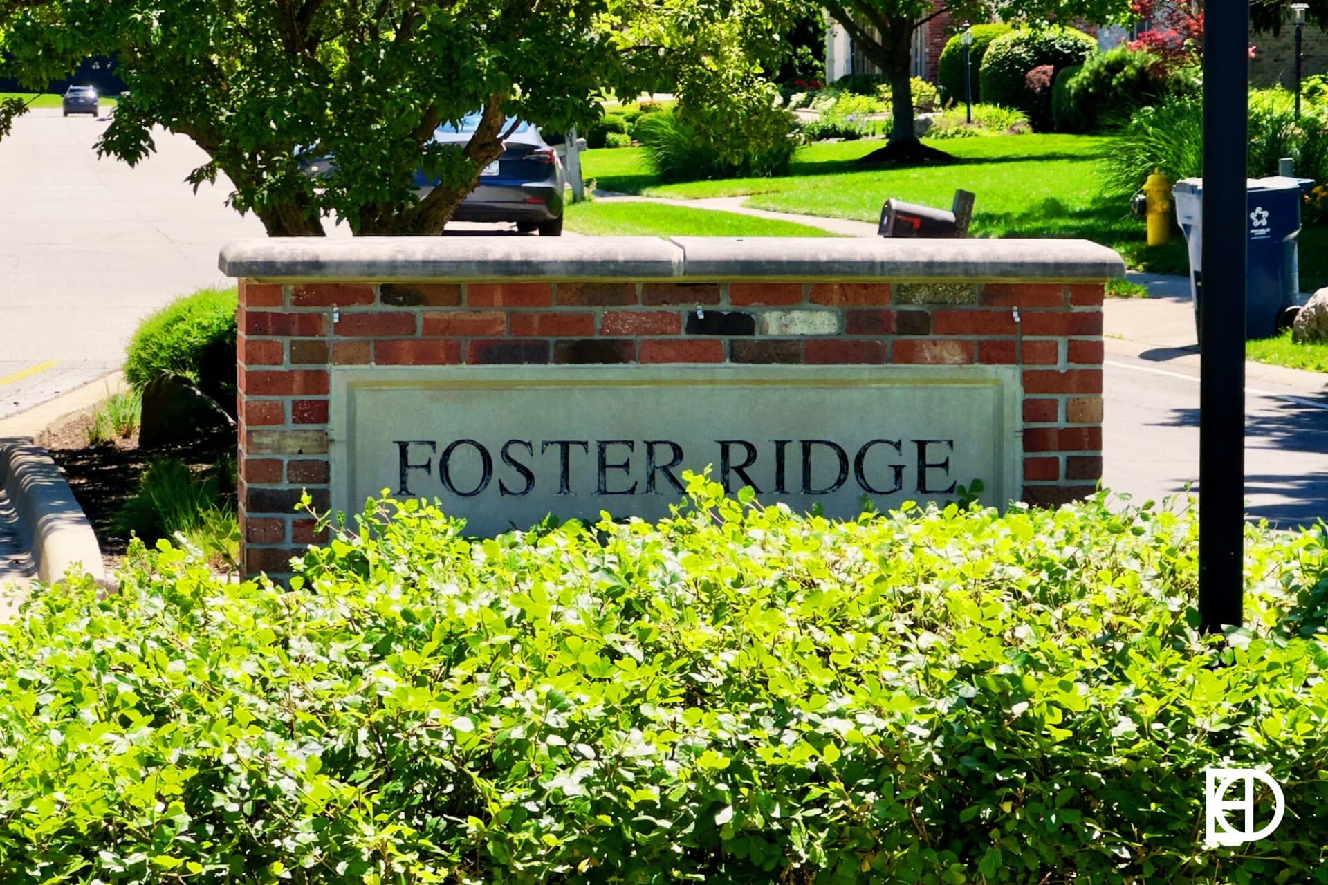 Exterior photo showing signage for Foster Ridge and landscaping