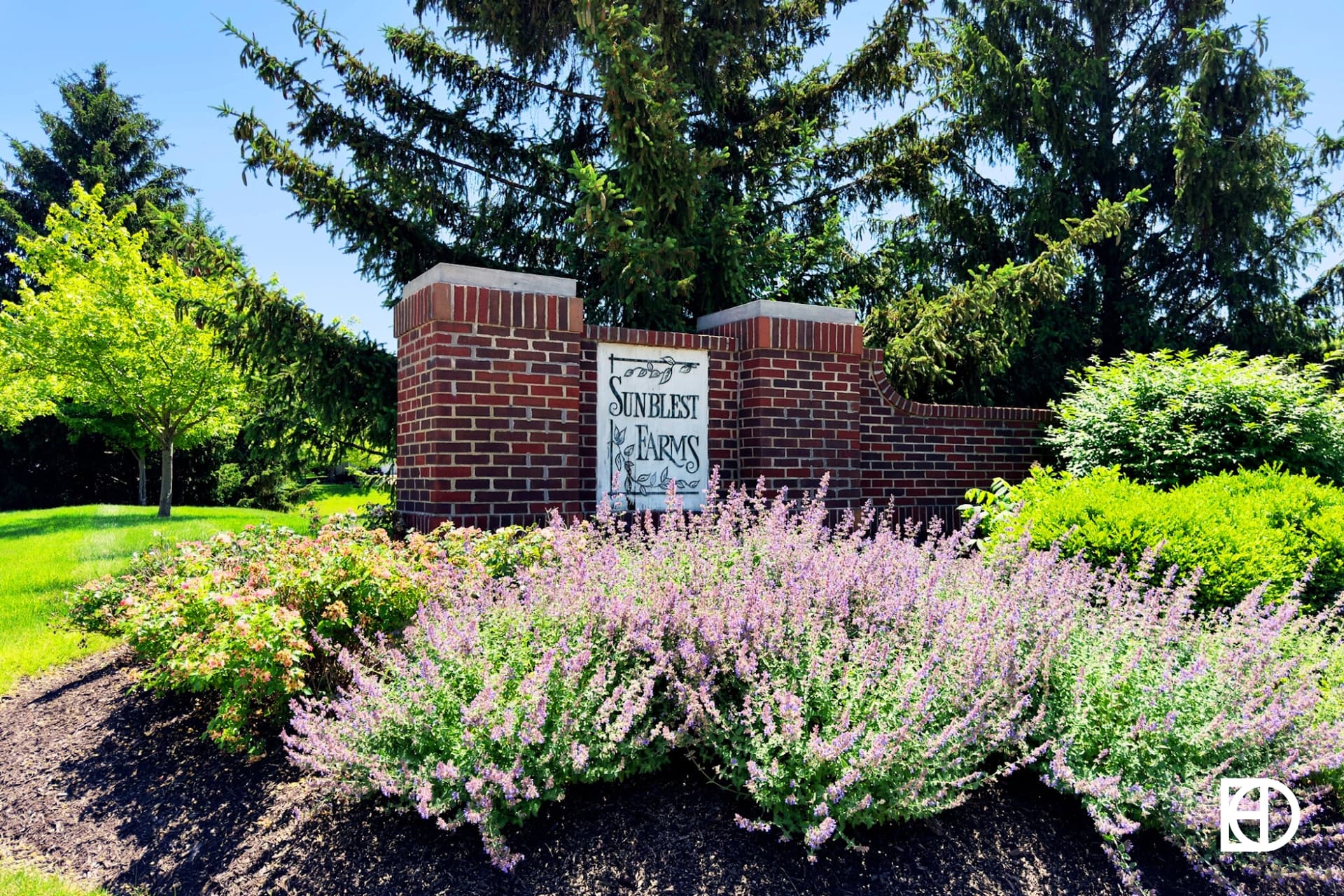 Exterior photo of Sunblest Farms, showing signage and landscaping