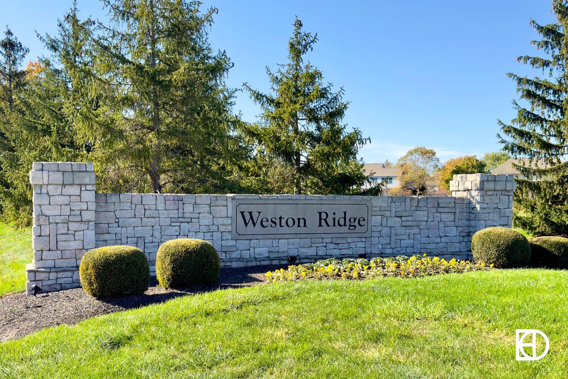 Exterior photo of Weston Ridge, showing signage and landscaping