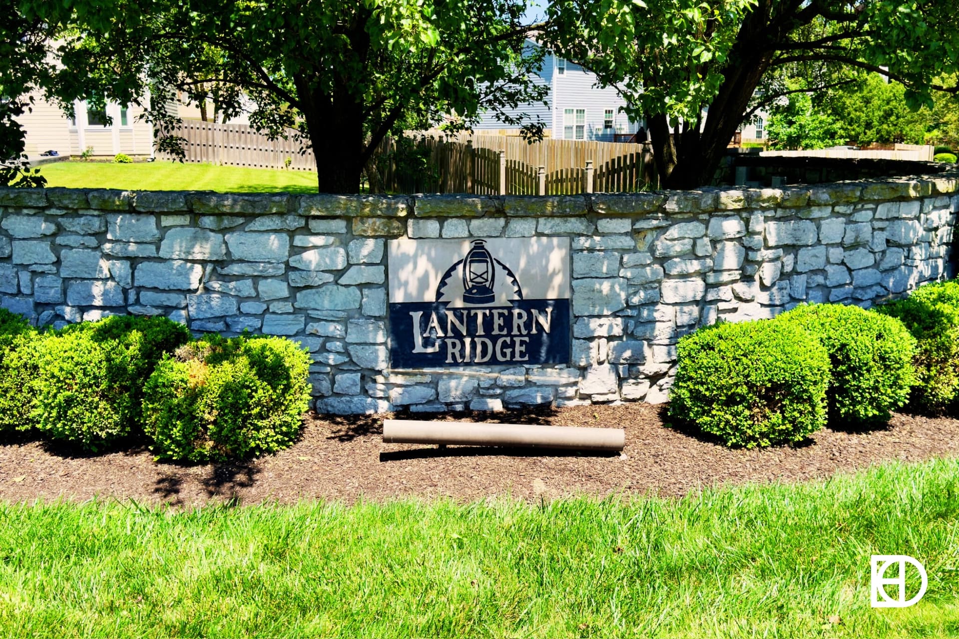 Exterior photo of Lantern Ridge, showing signage on low stone wall and landscaping