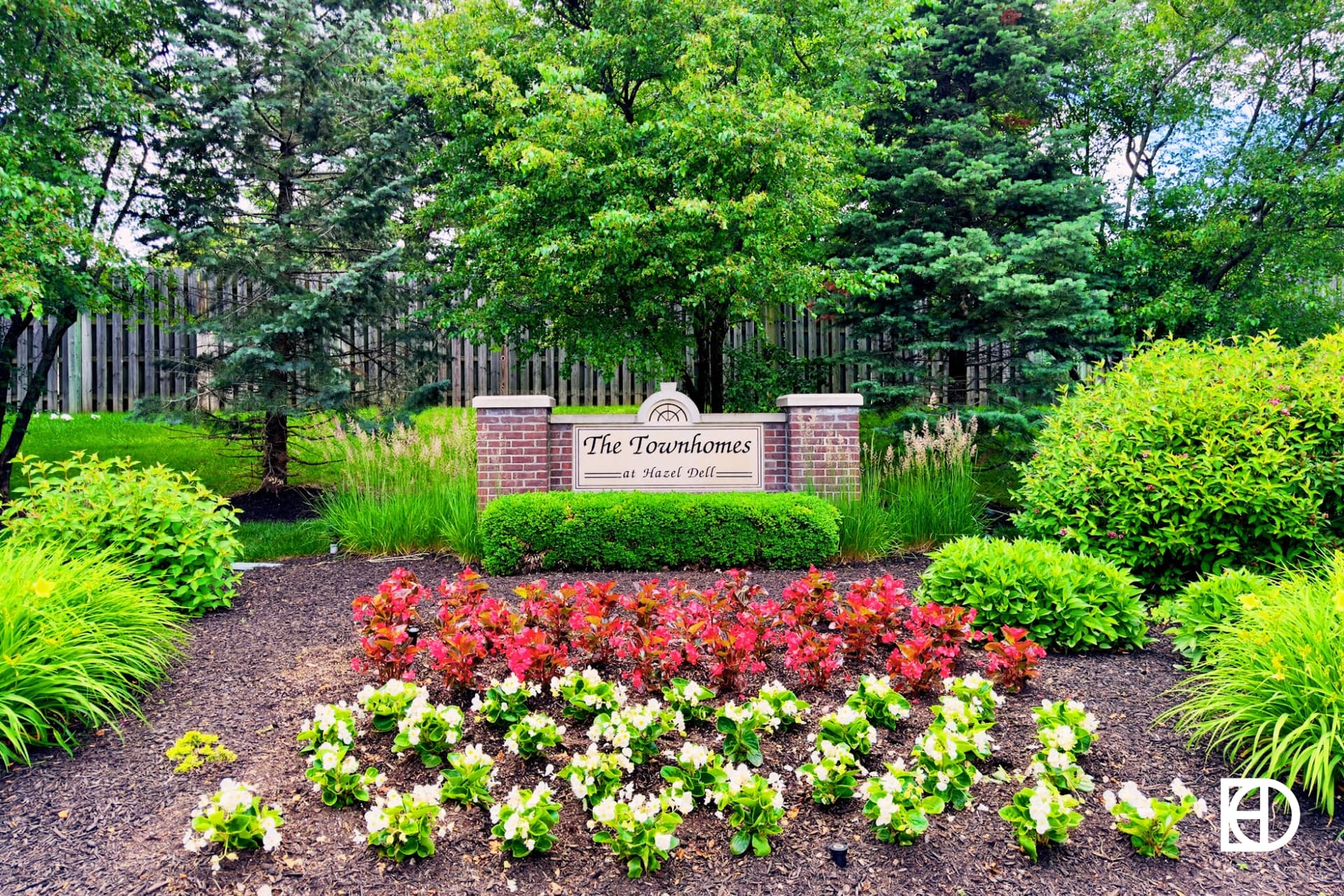 Exterior photo of Townhomes at Hazel Dell, showing signage and landscaping