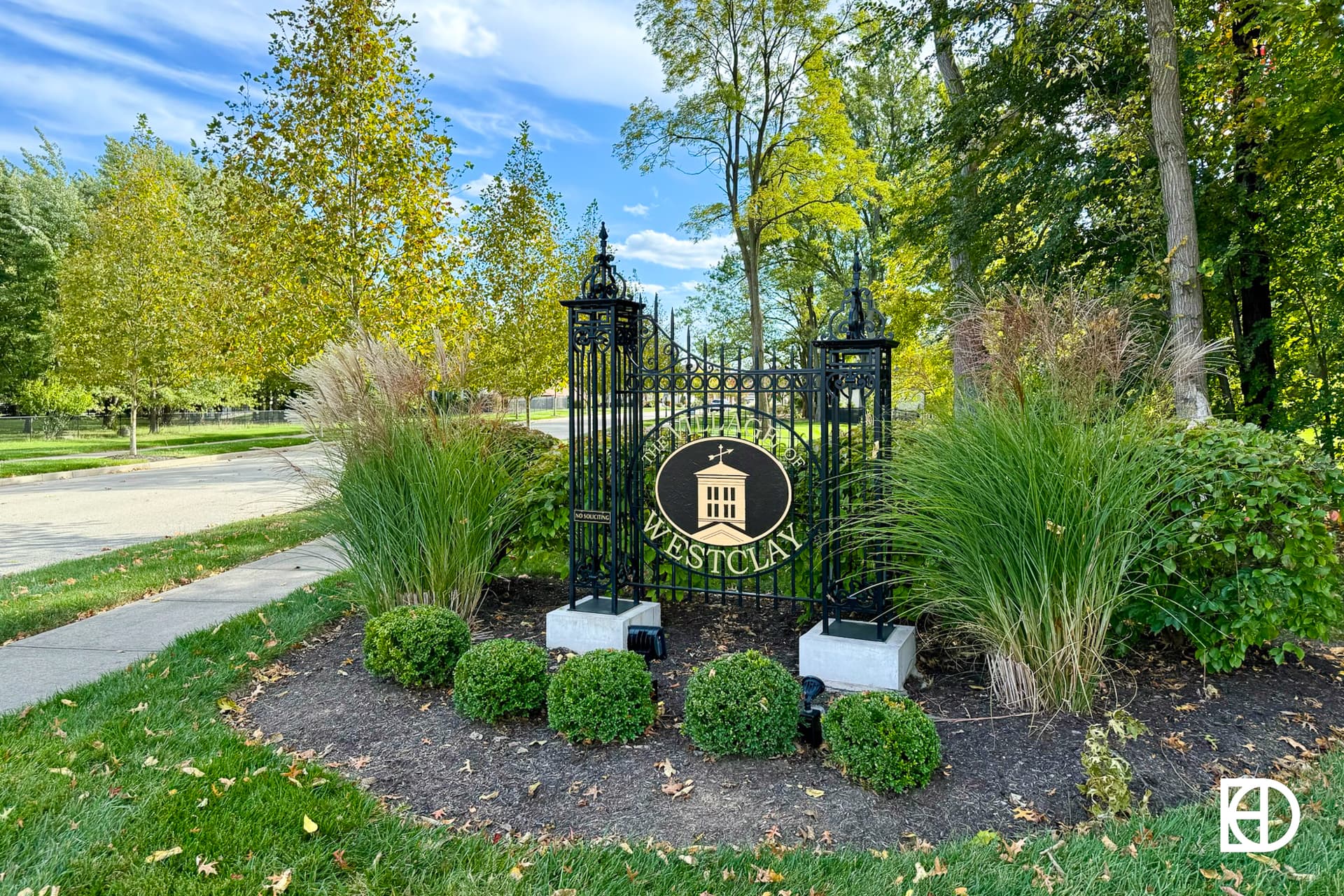 Exterior photo of Village of West Clay, showing signage and landscaping