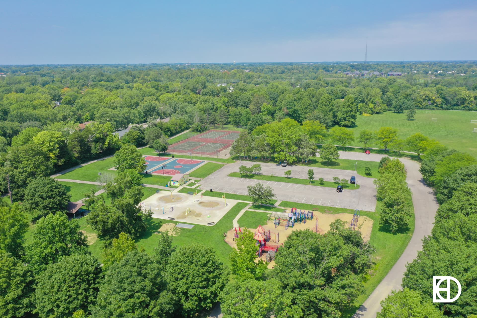 Aerial photo of Grassy Creek Regional Park in Warren Township, Indianapolis, showing playgrounds, tennis courts, and basketball courts.