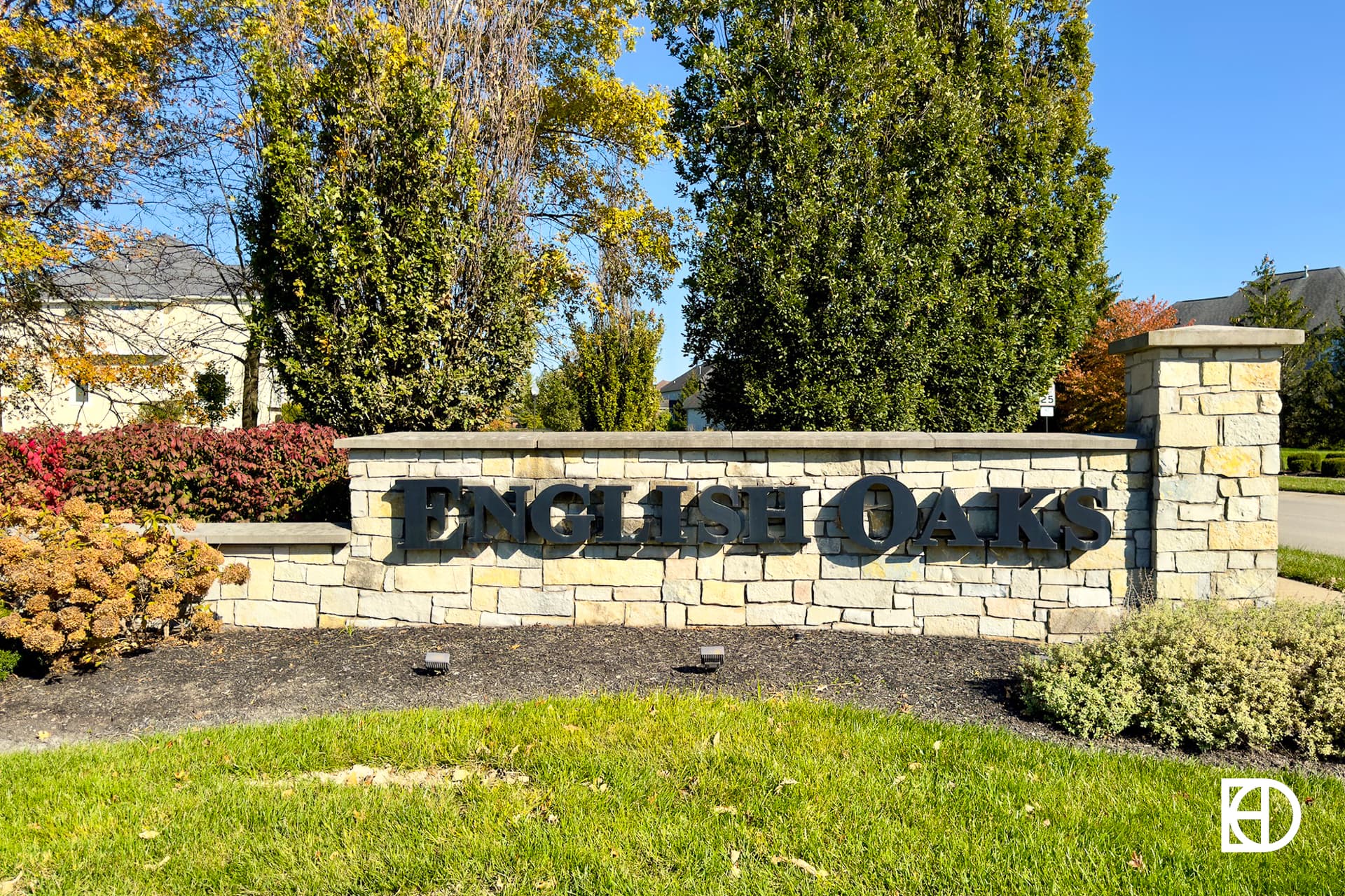 Exterior photo of English Oaks, showing signage and landscaping