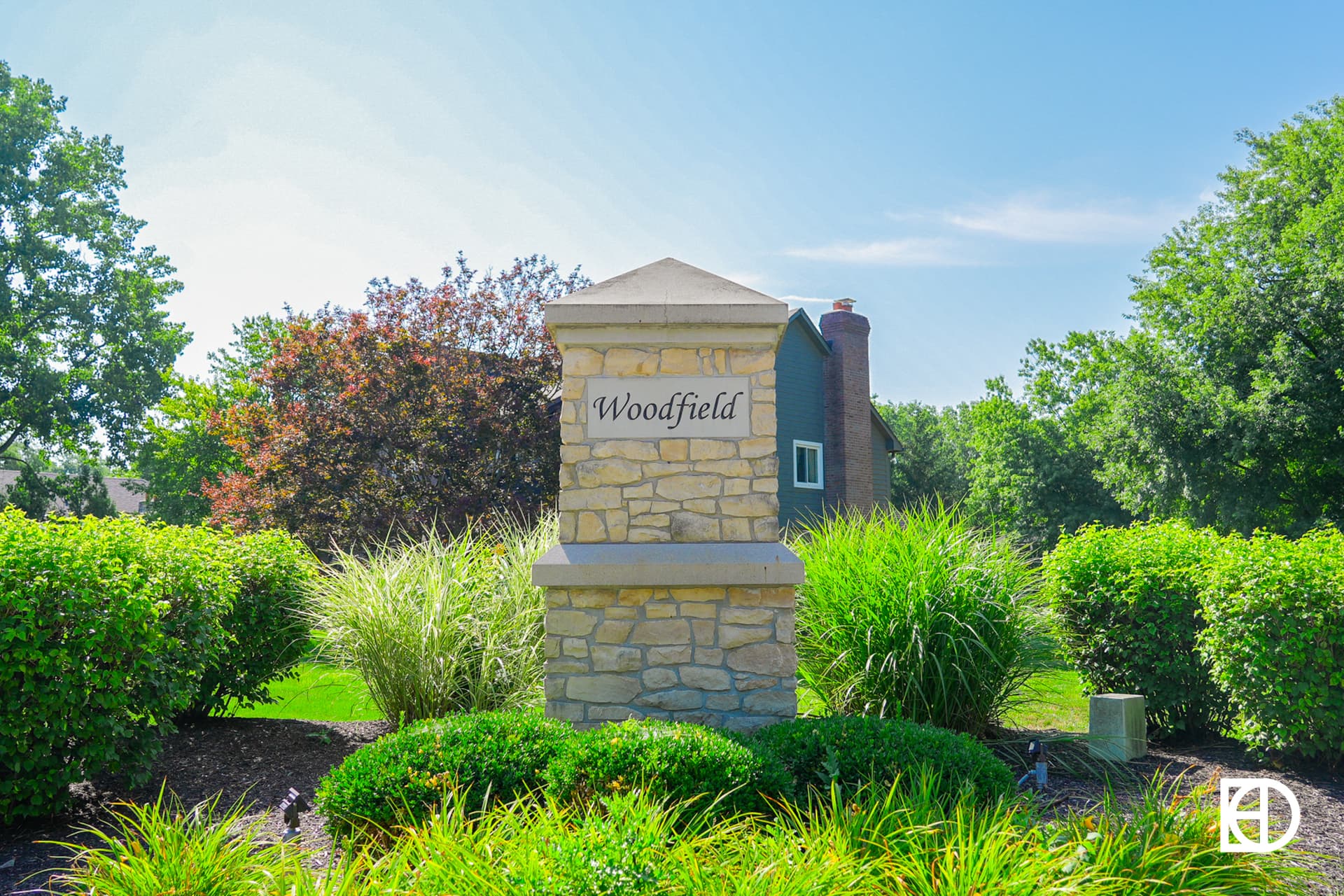 Exterior photo of Woodfield, showing signage and landscaping