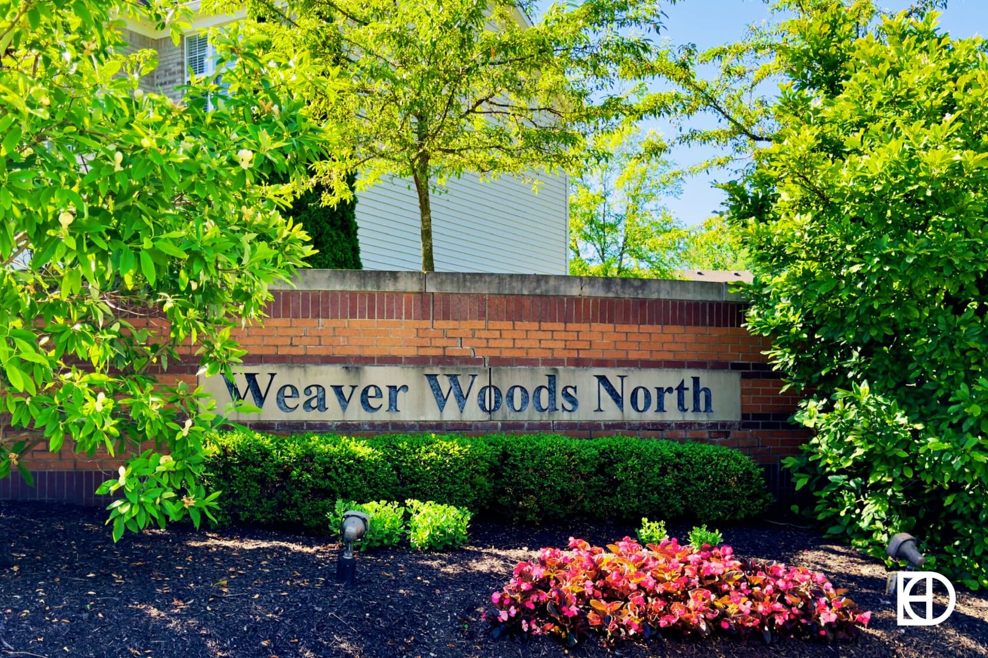 Exterior photo of Weaver Woods North, showing signage and landscaping