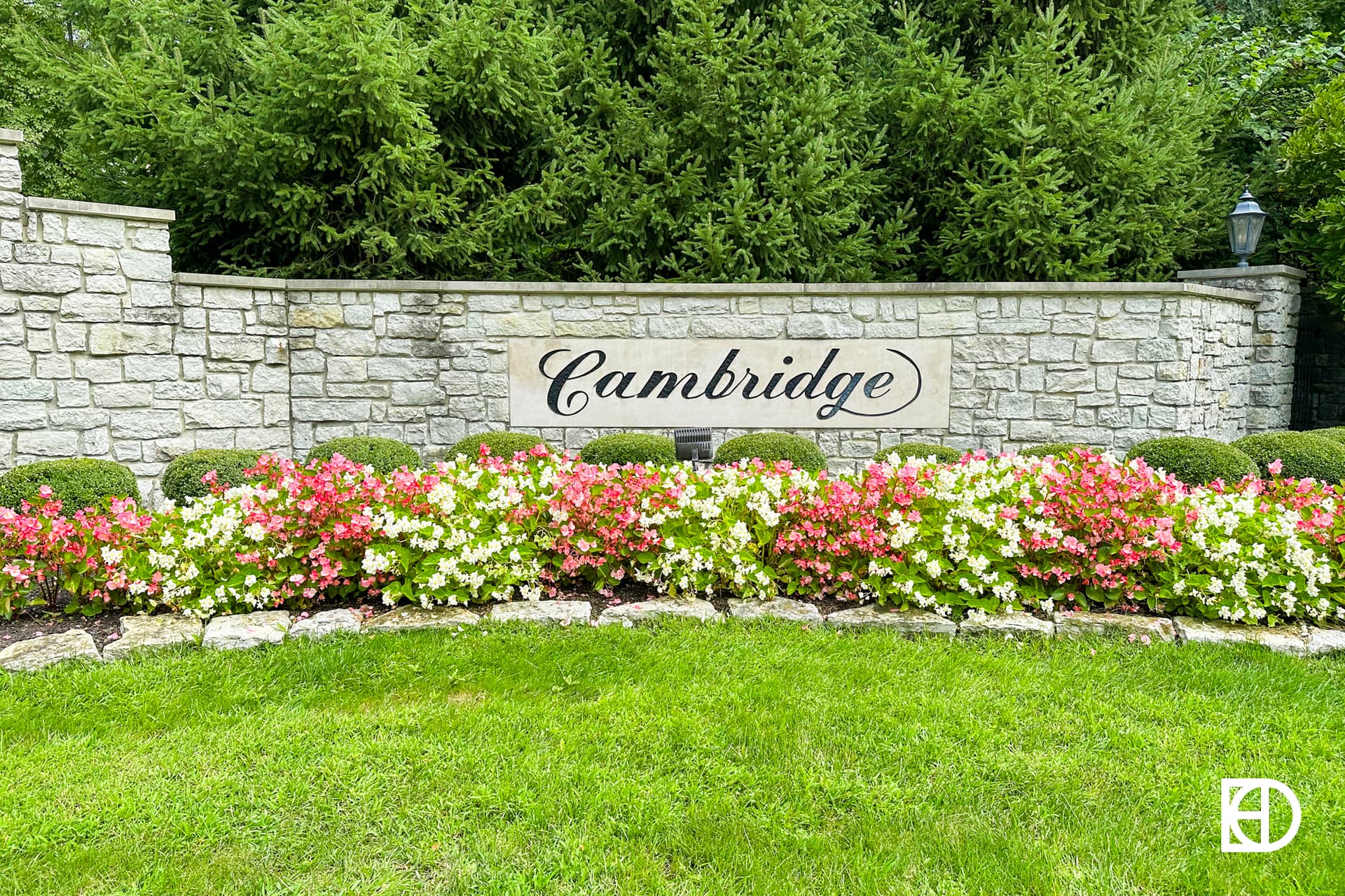 Exterior photo of Springs of Cambridge, showing signage and landscaping