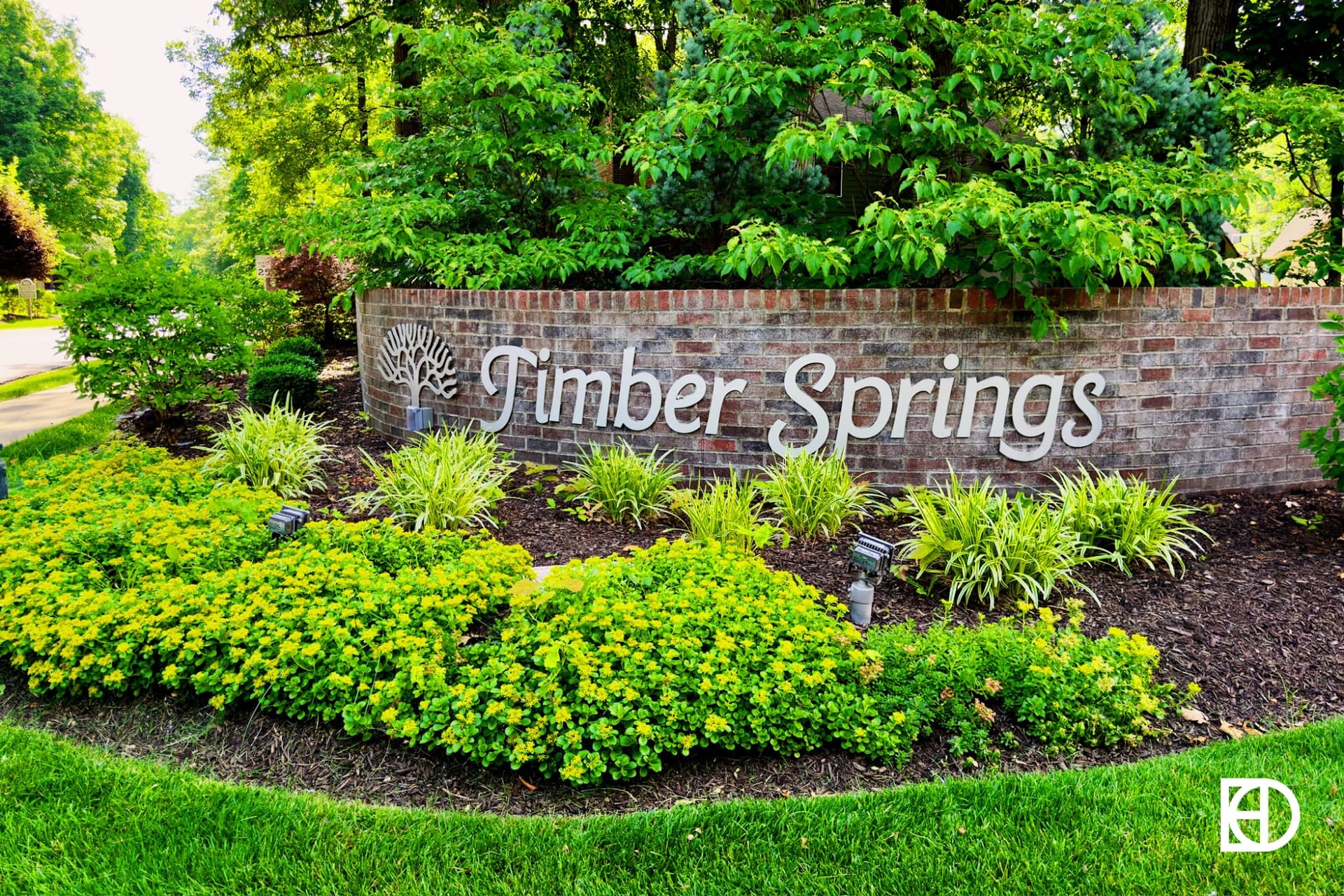 Exterior photo of Timber Springs, showing signage and landscaping
