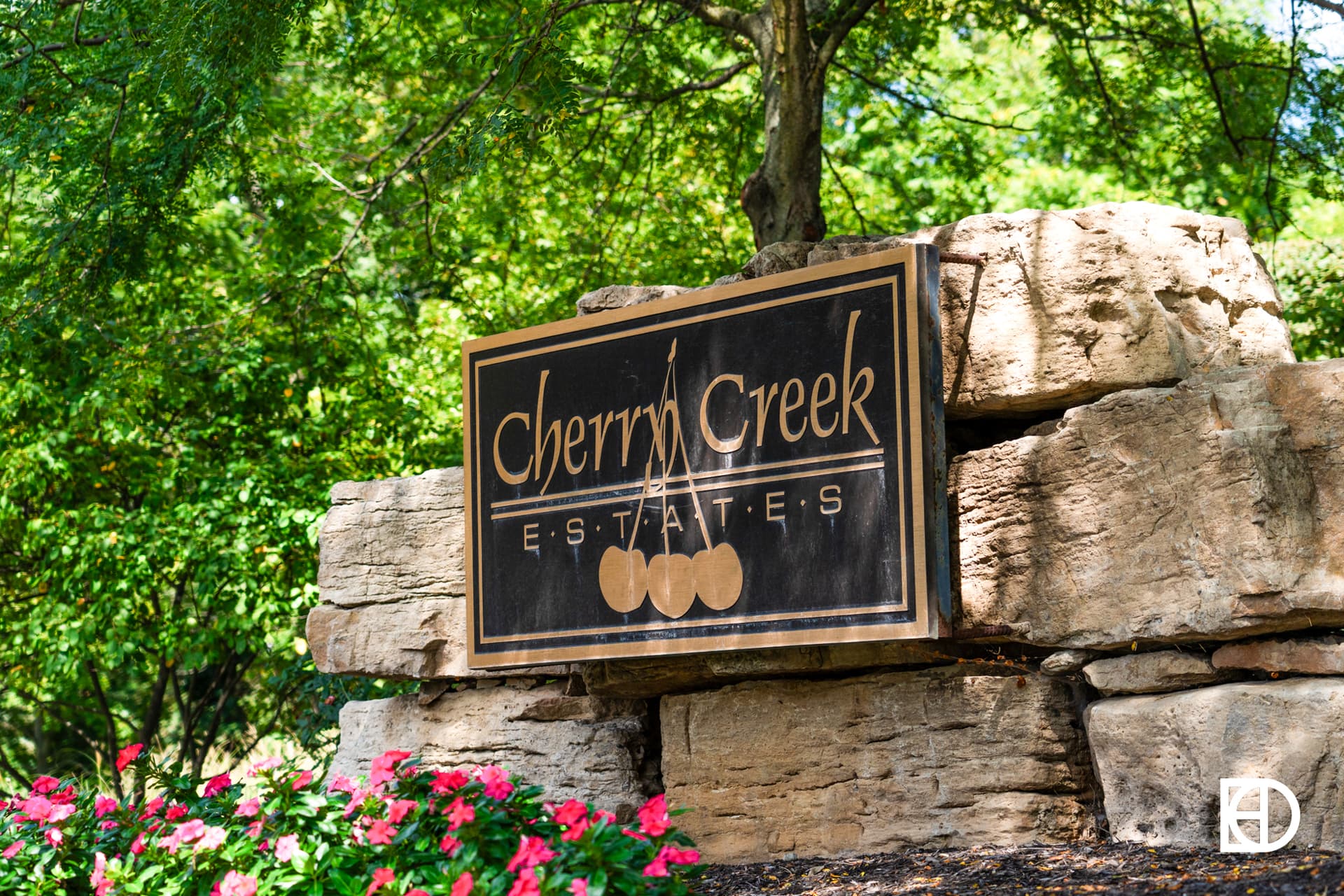 Exterior photo of Cherry Creek Estates, showing signage and landscaping