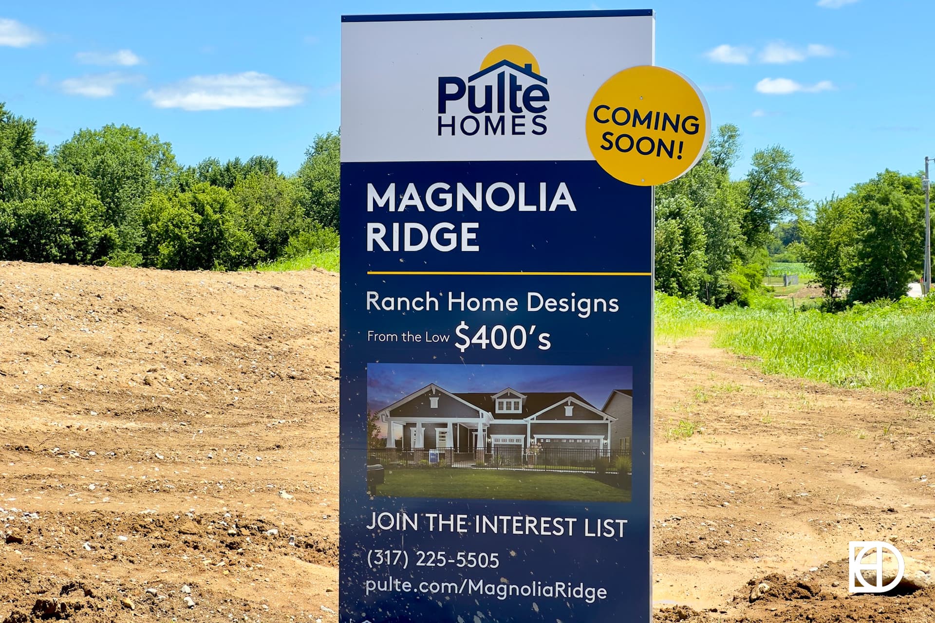 A Pulte Homes sign on a cleared lot advertises Magnolia Ridge ranch home designs from the low $400,000s, with a Coming Soon! label and contact details.
