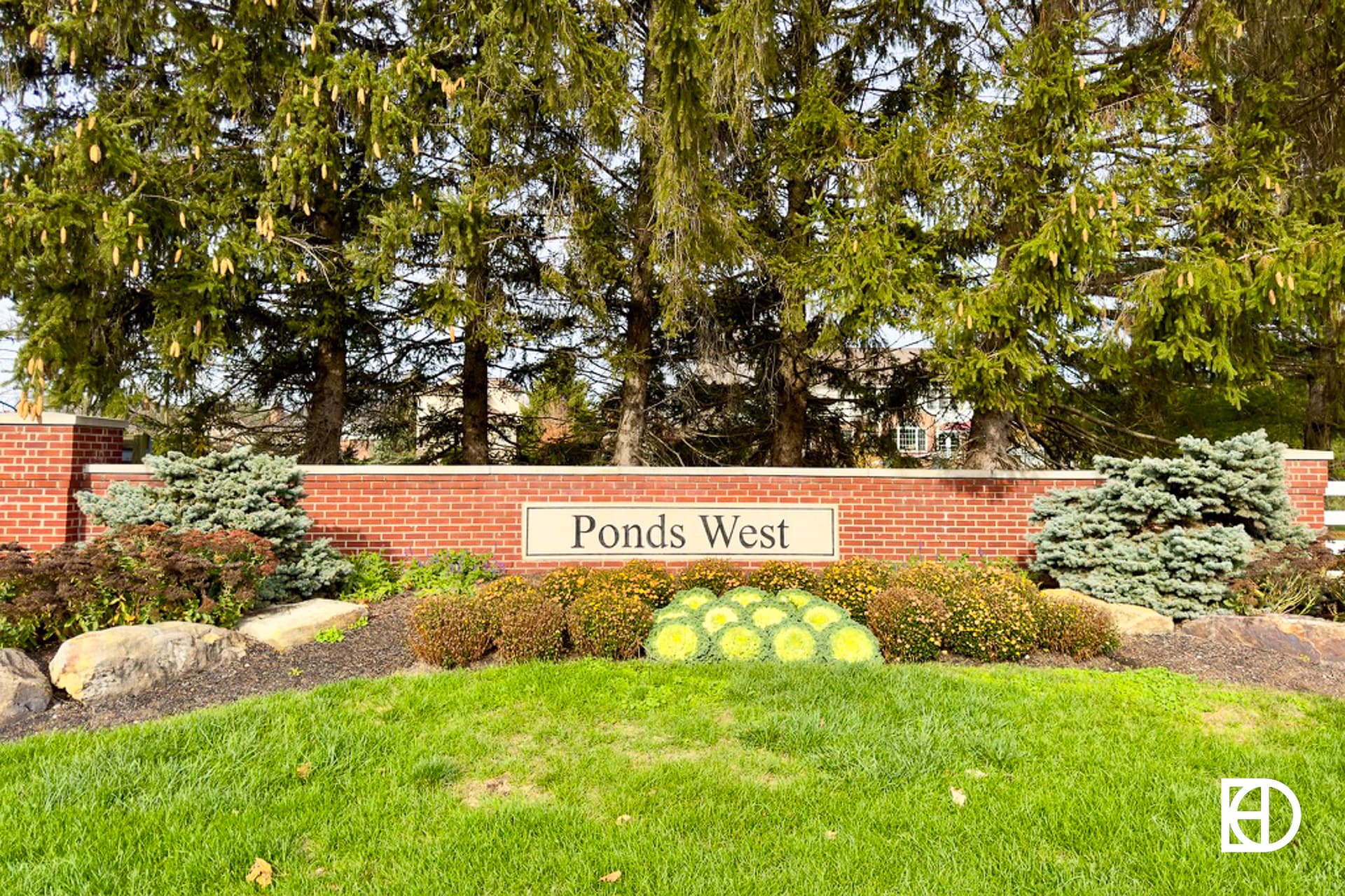Exterior photo of Ponds West, showing signage and landscaping