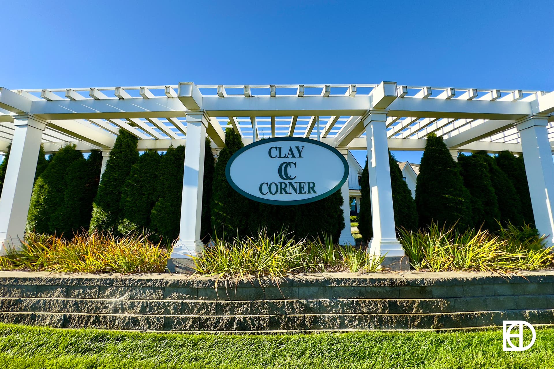 Exterior photo of Clay Corner, showing signage and landscaping