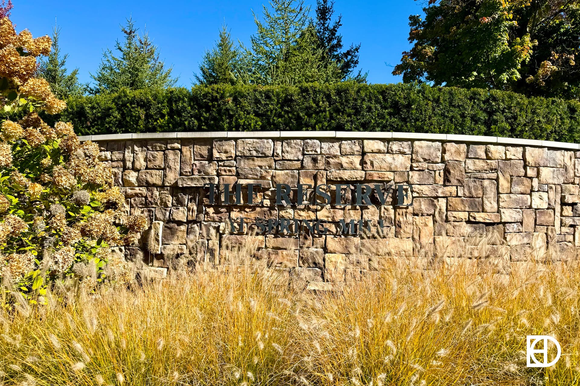 Exterior photo of Reserve at Springmill, showing signage and landscaping