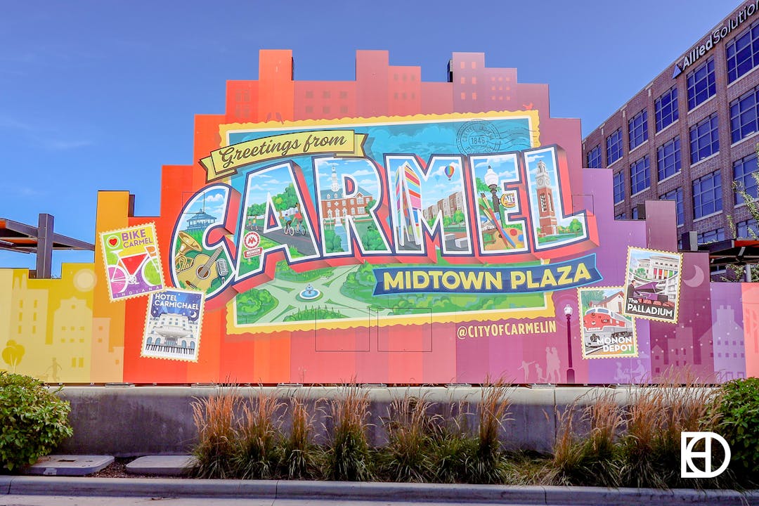 Large photo-opportunity signage mimicking a pop art postcard with "Greetings from Carmel"
